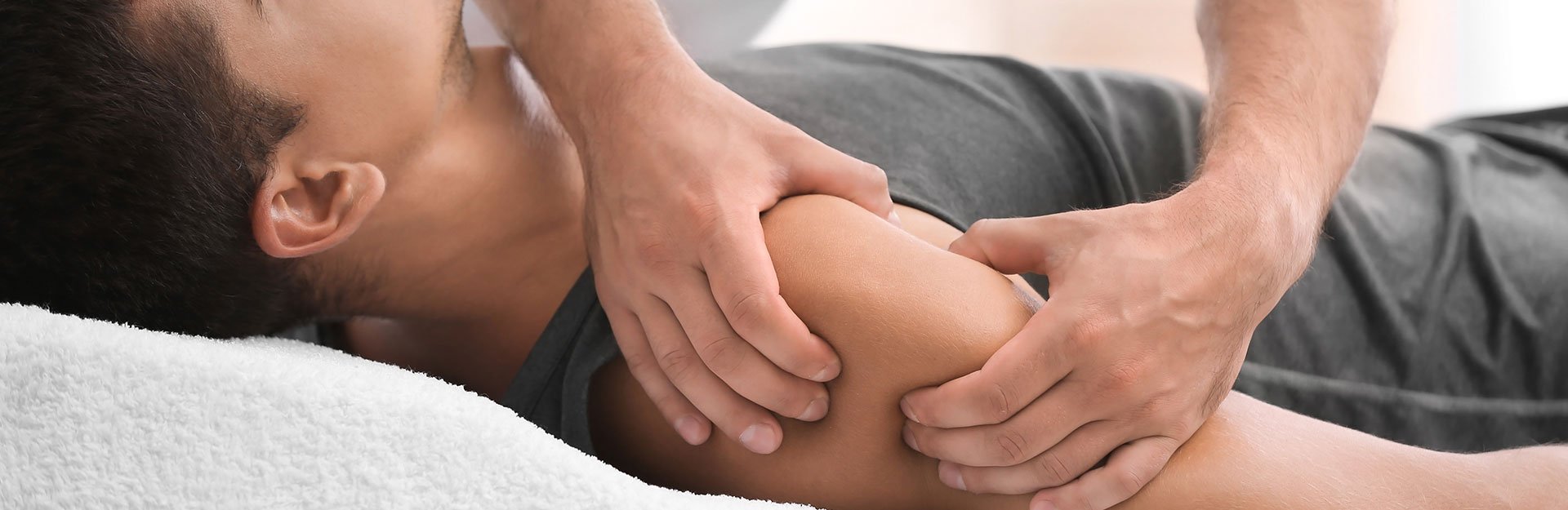 Massage therapist treating a client